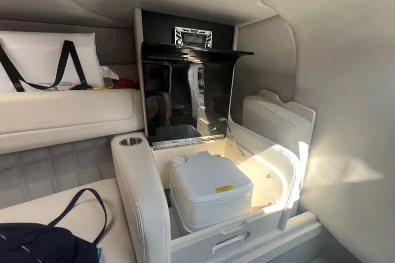 Slide: The Image of Interior of 2018 Formula 270 Sun Sport boat with compact amenities and storage. - 21