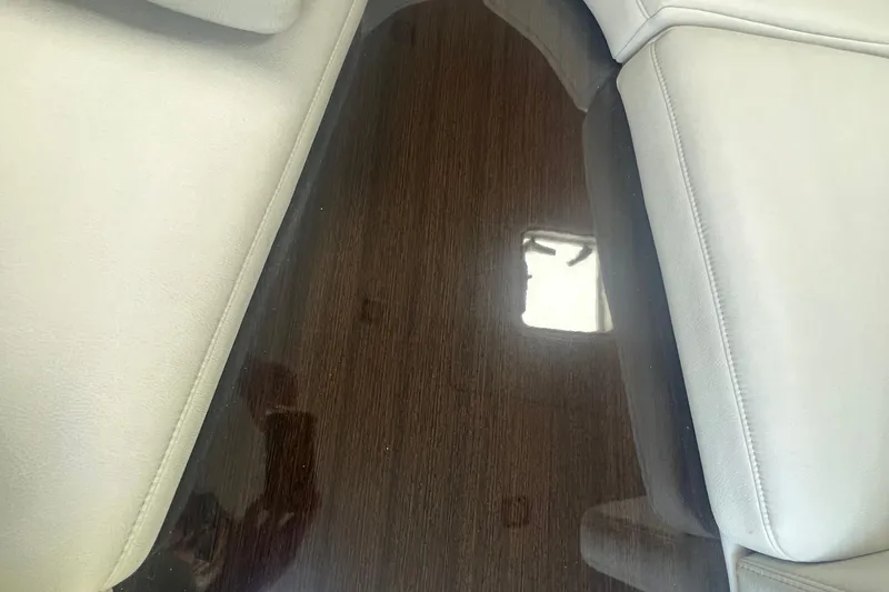 Slide: The Image of 2018 Formula 270 Sun Sport interior with sleek wood finish and light upholstery. - 22