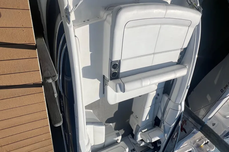 Slide: The Image of 2018 Formula 270 Sun Sport boat with white seating, docked beside a wooden pier. - 4