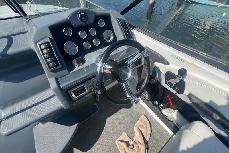 Slide: The Image of Cockpit of 2018 Formula 270 Sun Sport boat with steering wheel and control panel. - 7
