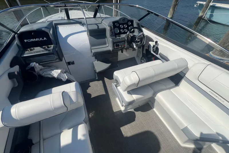 Slide: The Image of 2018 Formula 270 Sun Sport boat interior with white seating and control panel. - 8