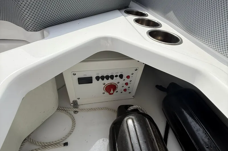 Slide: The Image of Interior of 2025 Scarab 235SE boat with control panel and cup holders. - 15