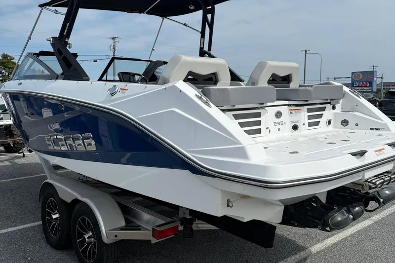 Slide: The Image of 2025 Scarab 235SE boat on trailer, featuring sleek design and modern seating. - 6