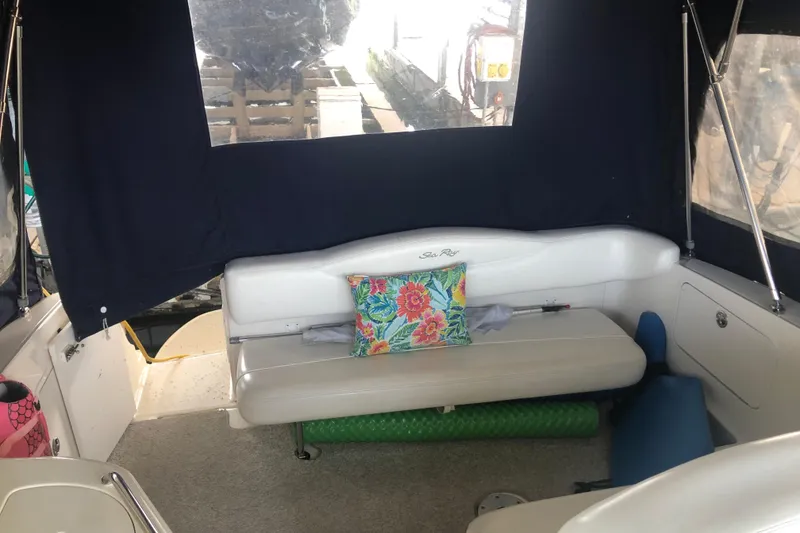 Slide: The Image of 2004 Sea Ray 280 Sundancer interior with floral cushion and seating area. - 10