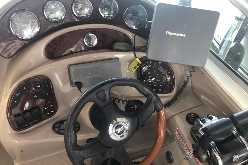 Slide: The Image of Dashboard of a 2004 Sea Ray 280 Sundancer boat with Raymarine navigation system. - 11