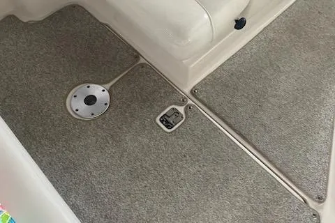 Slide: The Image of 2004 Sea Ray 280 Sundancer interior with carpeted flooring and seating area. - 13