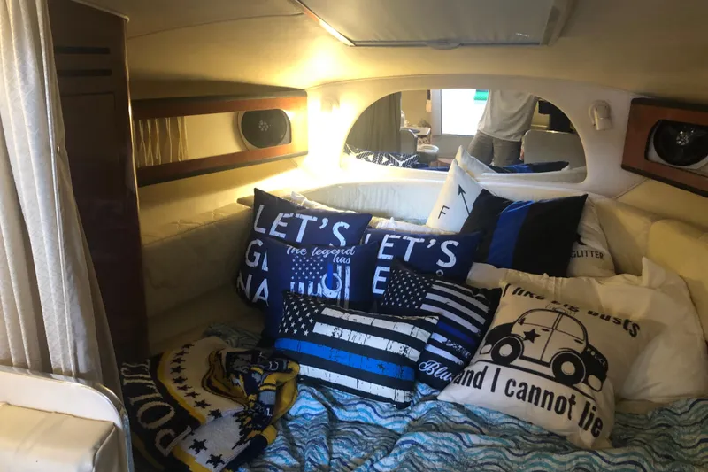 Slide: The Image of Cozy cabin interior of 2004 Sea Ray 280 Sundancer with decorative pillows and bedding. - 16