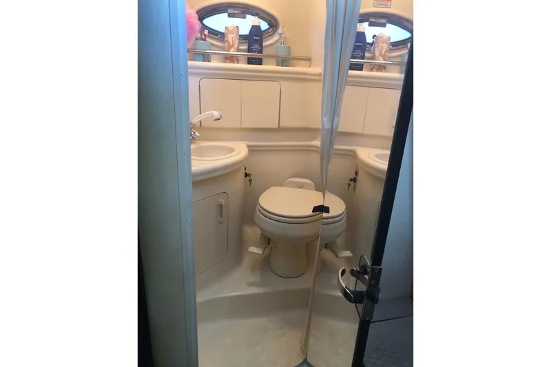 Slide: The Image of Bathroom interior of 2004 Sea Ray 280 Sundancer boat, featuring sink and toilet. - 22