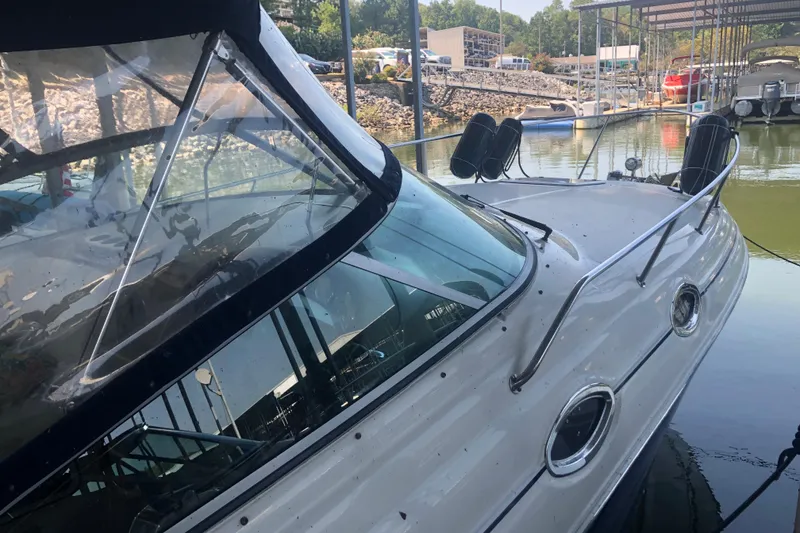 Slide: The Image of 2004 Sea Ray 280 Sundancer docked at marina, featuring sleek design and clear windows. - 5