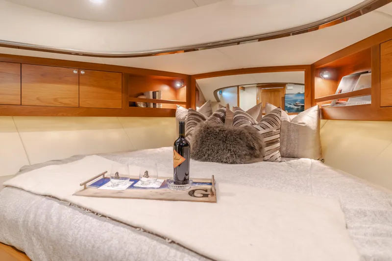 Slide: The Image of Luxurious cabin interior of 2015 Palm Beach Motor Yachts 45 Sedan with cozy bedding and wine. - 15
