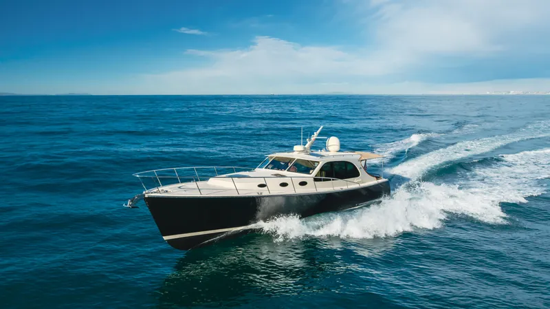Slide: The Image of 2015 Palm Beach Motor Yachts 45 Sedan cruising on open ocean waters. - 18