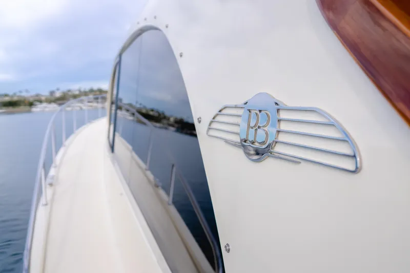 Slide: The Image of 2015 Palm Beach Motor Yachts 45 Sedan, side view with logo, on calm water. - 24