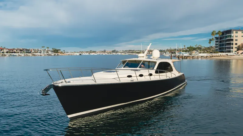 Slide: The Image of 2015 Palm Beach Motor Yachts 45 Sedan cruising in a serene coastal setting. - 30