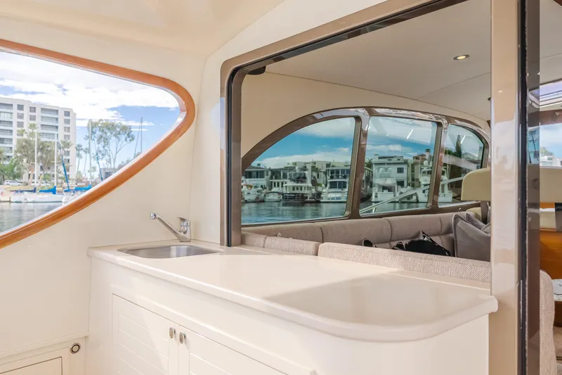 Slide: The Image of Interior view of 2015 Palm Beach Motor Yachts 45 Sedan, featuring sleek design and marina backdrop. - 31