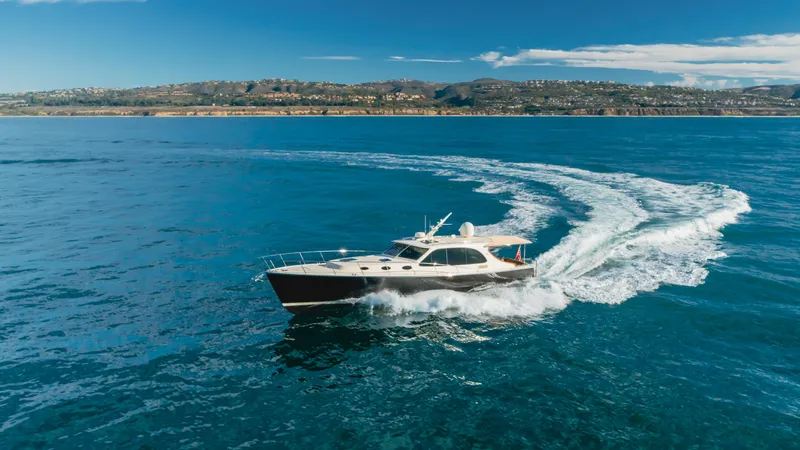 Slide: The Image of 2015 Palm Beach Motor Yachts 45 Sedan cruising on open water. - 34