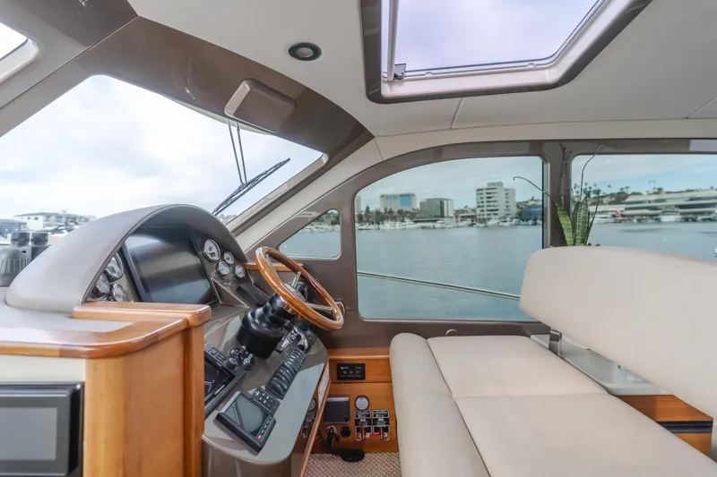Slide: The Image of Interior of 2015 Palm Beach Motor Yachts 45 Sedan, featuring helm and seating area. - 37