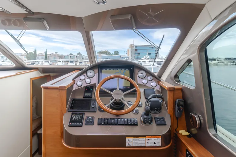 Slide: The Image of Helm of 2015 Palm Beach Motor Yachts 45 Sedan with modern navigation controls. - 39