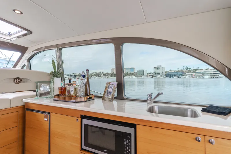 Slide: The Image of Interior of 2015 Palm Beach Motor Yachts 45 Sedan with kitchenette and waterfront view. - 41