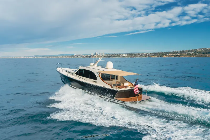 Slide: The Image of 2015 Palm Beach Motor Yachts 45 Sedan cruising on open water. - 42