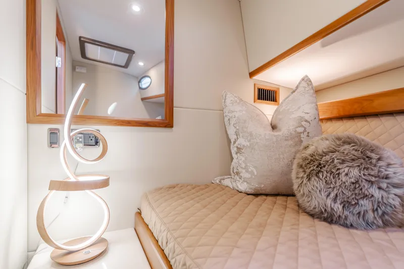 Slide: The Image of Luxurious interior of 2015 Palm Beach Motor Yachts 45 Sedan with elegant bedding and modern lamp. - 46