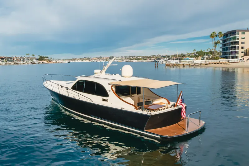 Slide: The Image of 2015 Palm Beach Motor Yachts 45 Sedan cruising in a scenic harbor. - 49