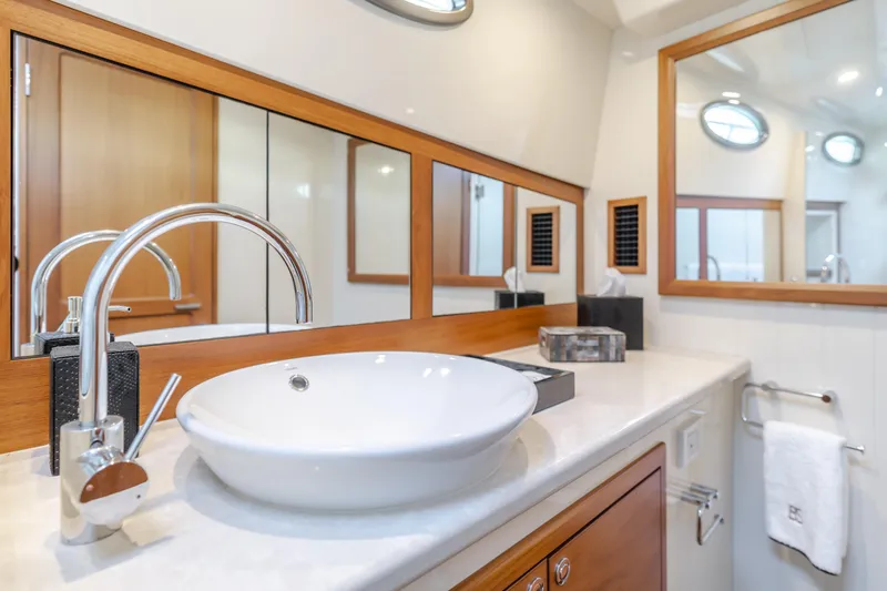 Slide: The Image of Luxurious bathroom in 2015 Palm Beach Motor Yachts 45 Sedan with modern fixtures and wood accents. - 52