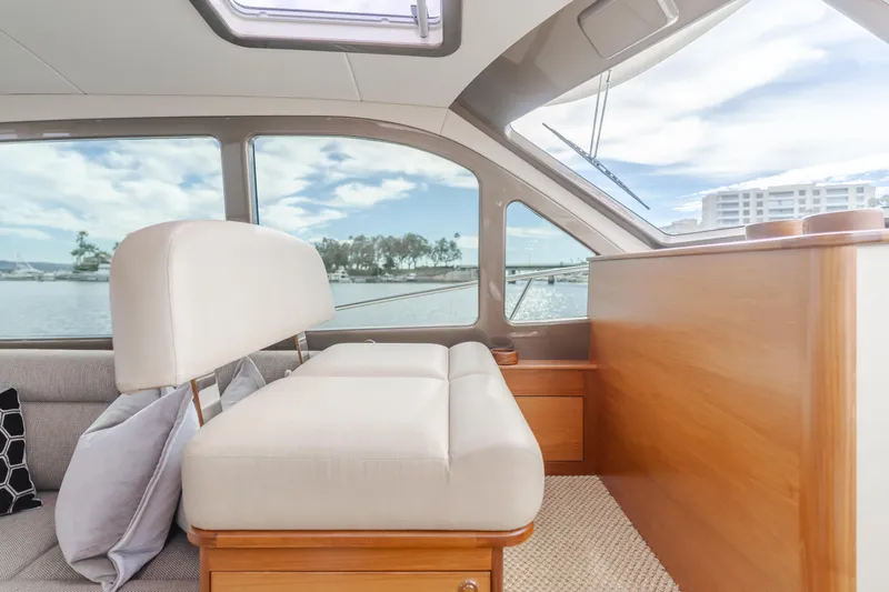 Slide: The Image of Interior of 2015 Palm Beach Motor Yachts 45 Sedan with elegant seating and scenic window view. - 6
