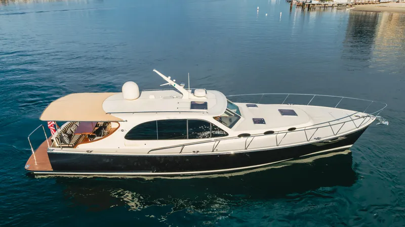Slide: The Image of 2015 Palm Beach Motor Yachts 45 Sedan cruising on calm waters. - 7