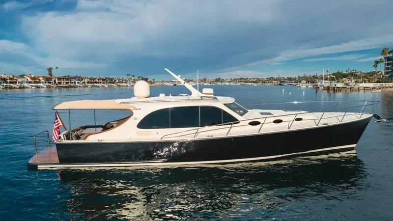Slide: The Image of 2015 Palm Beach Motor Yachts 45 Sedan cruising on calm waters under a blue sky. - 9