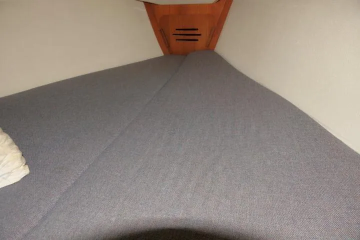 Slide: The Image of Interior cabin of a 1995 Tartan 3100 sailboat with a neatly made bed. - 20