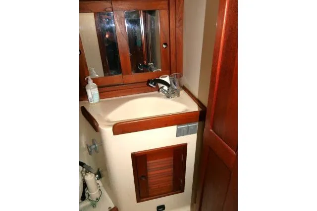 Slide: The Image of 1995 Tartan 3100 yacht bathroom with wooden cabinetry and sink. - 23