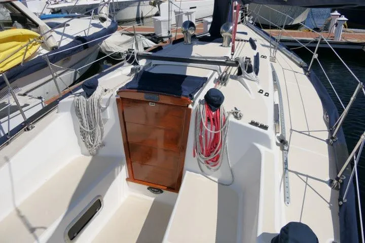 Slide: The Image of Sailboat cockpit of a 1995 Tartan 3100, featuring ropes and wooden hatch. - 24