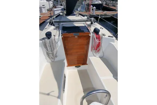 Slide: The Image of 1995 Tartan 3100 sailboat cockpit with ropes and wooden hatch in marina. - 25
