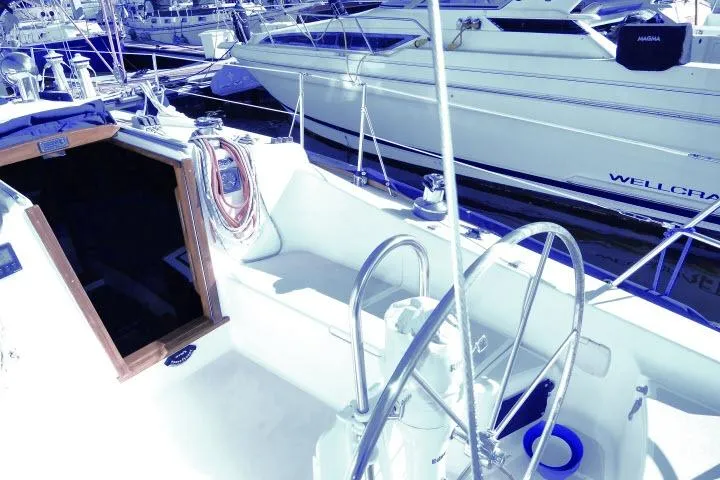 Slide: The Image of Sailboat cockpit of a 1995 Tartan 3100, docked alongside other boats. - 26