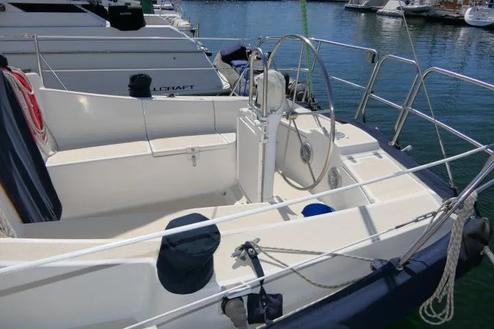 Slide: The Image of 1995 Tartan 3100 sailboat cockpit with steering wheel, docked at marina. - 30