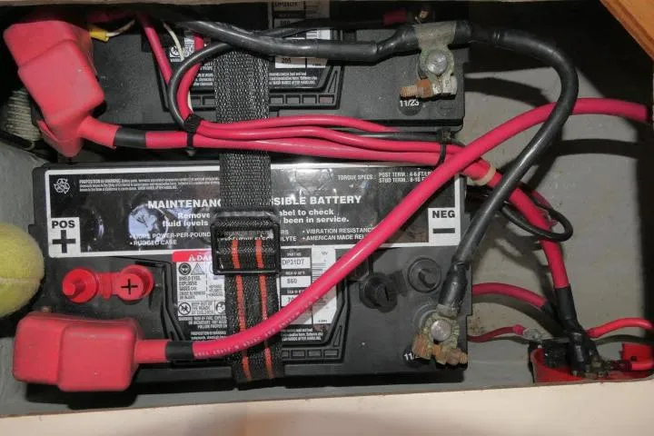 Slide: The Image of Battery compartment of a 1995 Tartan 3100 with red and black cables. - 39