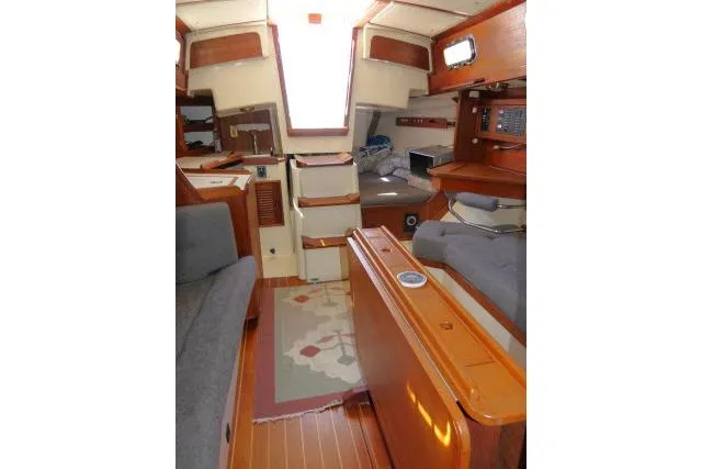 Slide: The Image of Interior of a 1995 Tartan 3100 sailboat with wood finishes and seating area. - 9