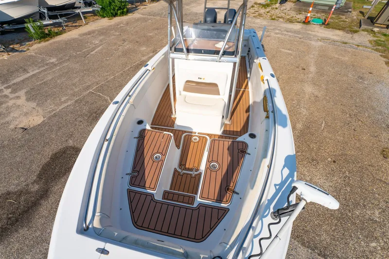 Slide: The Image of 2011 Sea Hunt Gamefish 25 boat with wood deck, docked on concrete. - 13