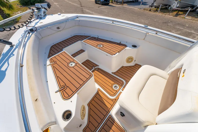 Slide: The Image of 2011 Sea Hunt Gamefish 25 boat interior with teak-style flooring and seating. - 14