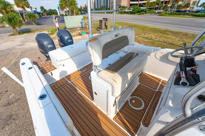Slide: The Image of 2011 Sea Hunt Gamefish 25 boat interior with dual engines and teak flooring. - 15