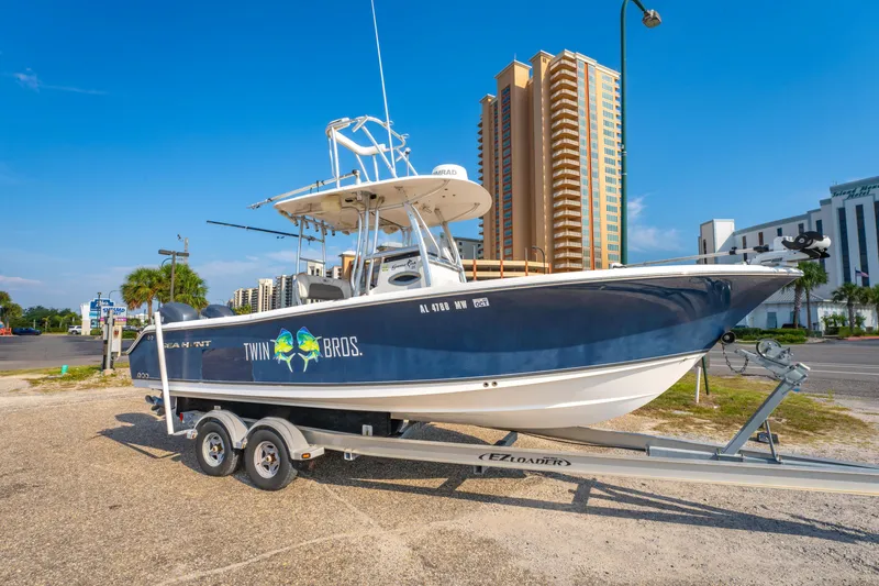 Slide: The Image of 2011 Sea Hunt Gamefish 25 boat on trailer, urban background, sunny day. - 2