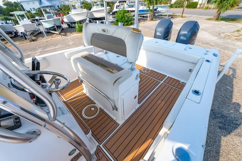 Slide: The Image of 2011 Sea Hunt Gamefish 25 boat interior with dual engines and teak flooring. - 20
