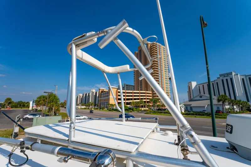 Slide: The Image of 2011 Sea Hunt Gamefish 25 boat with cityscape background and clear blue sky. - 24