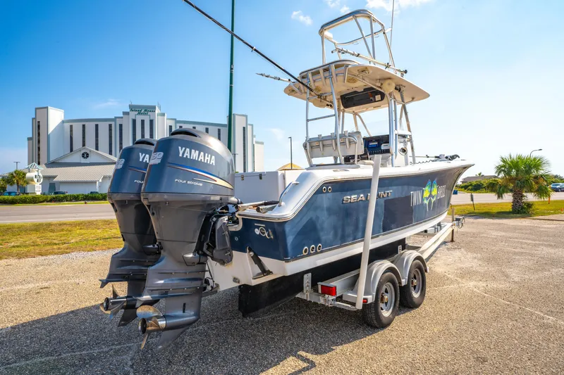 Slide: The Image of 2011 Sea Hunt Gamefish 25 boat with twin Yamaha engines on a trailer. - 5