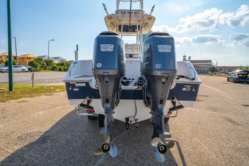Slide: The Image of 2011 Sea Hunt Gamefish 25 with dual Yamaha 150 engines, parked on a sunny day. - 6