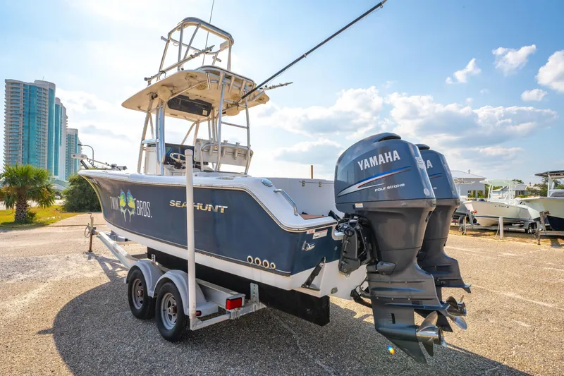Slide: The Image of 2011 Sea Hunt Gamefish 25 boat with twin Yamaha engines on a trailer. - 7