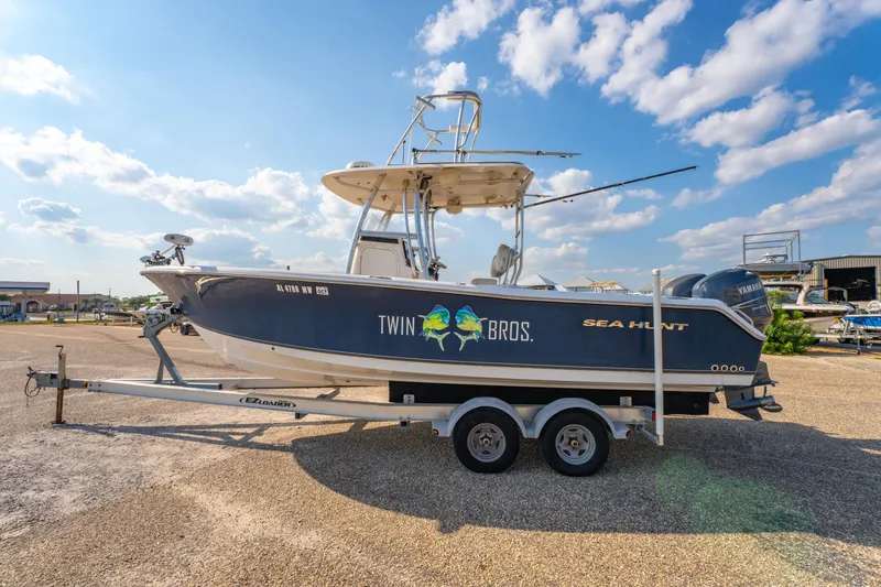 Slide: The Image of 2011 Sea Hunt Gamefish 25 boat on trailer under blue sky. - 8