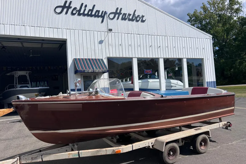 Slide: The Image of 1955 Chris-Craft 17 Cavalier boat on trailer outside Holiday Harbor showroom. - 0