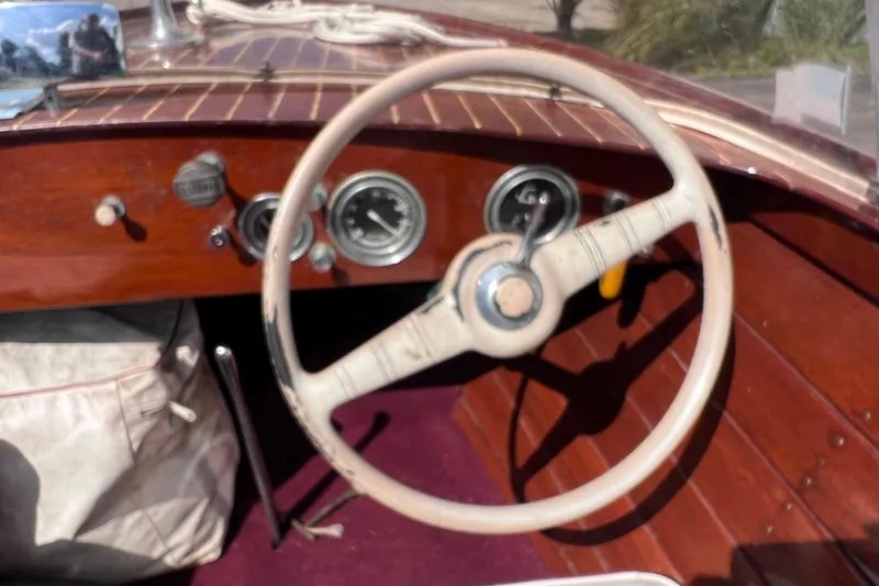 Slide: The Image of 1955 Chris-Craft 17 Cavalier boat dashboard with vintage steering wheel and gauges. - 13