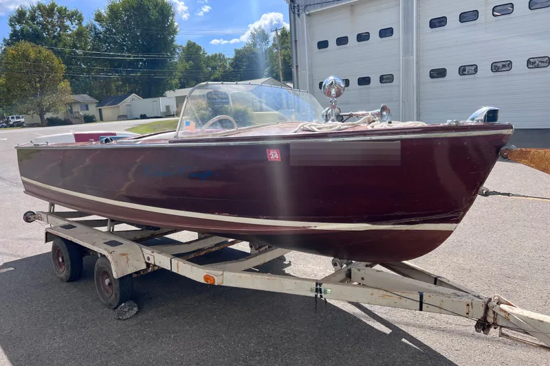 Slide: The Image of 1955 Chris-Craft 17 Cavalier boat on trailer, parked outdoors. - 15